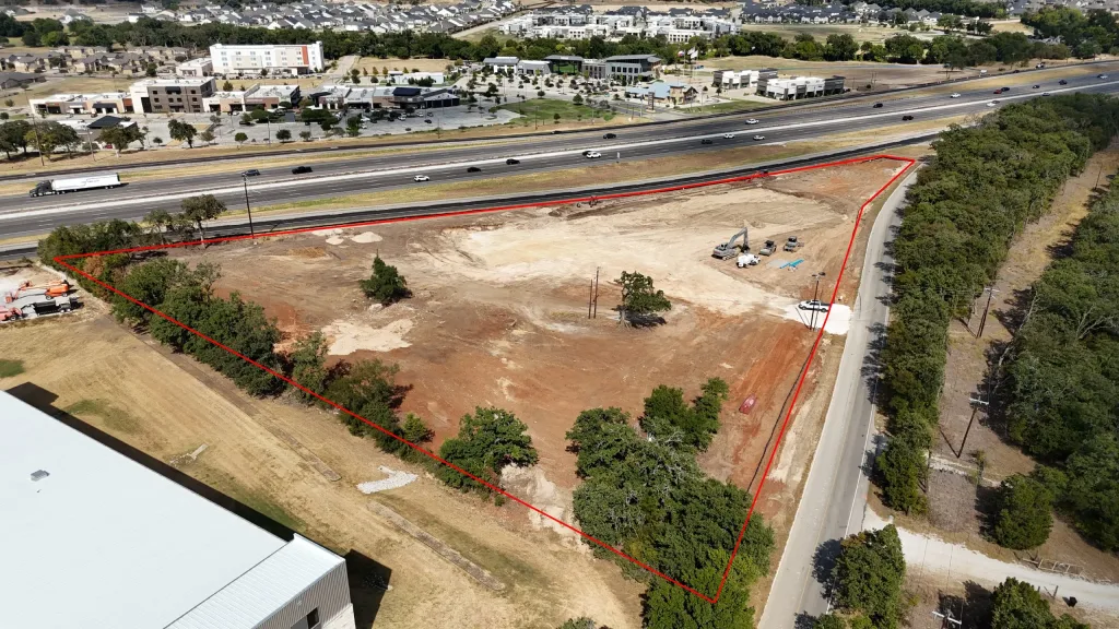 Drone photo from the southwest of the 20 West site today, outlined in red, with Interstate 20 beyond